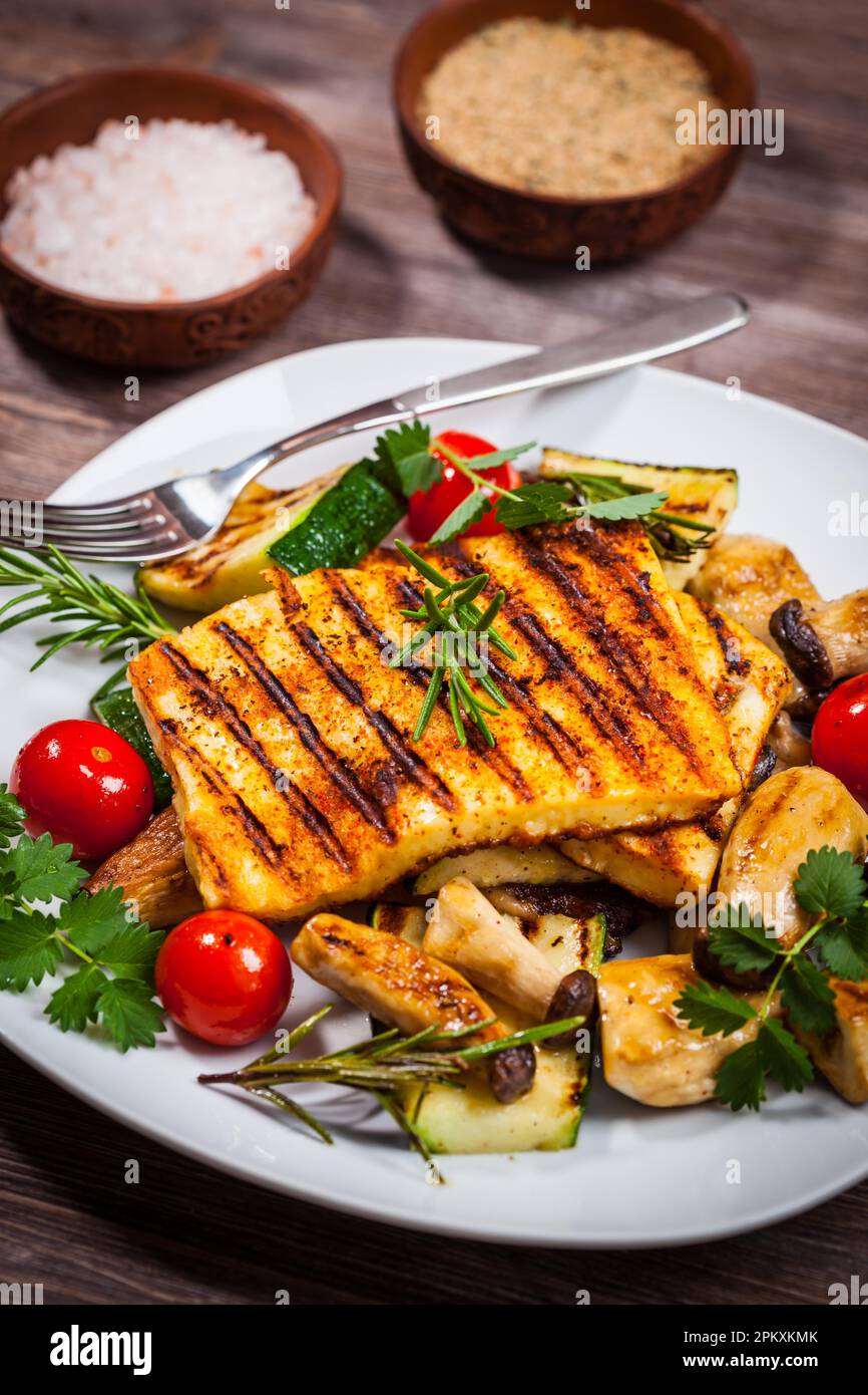 Halloumi grilled cheese on mushrooms and vegetables Stock Photo