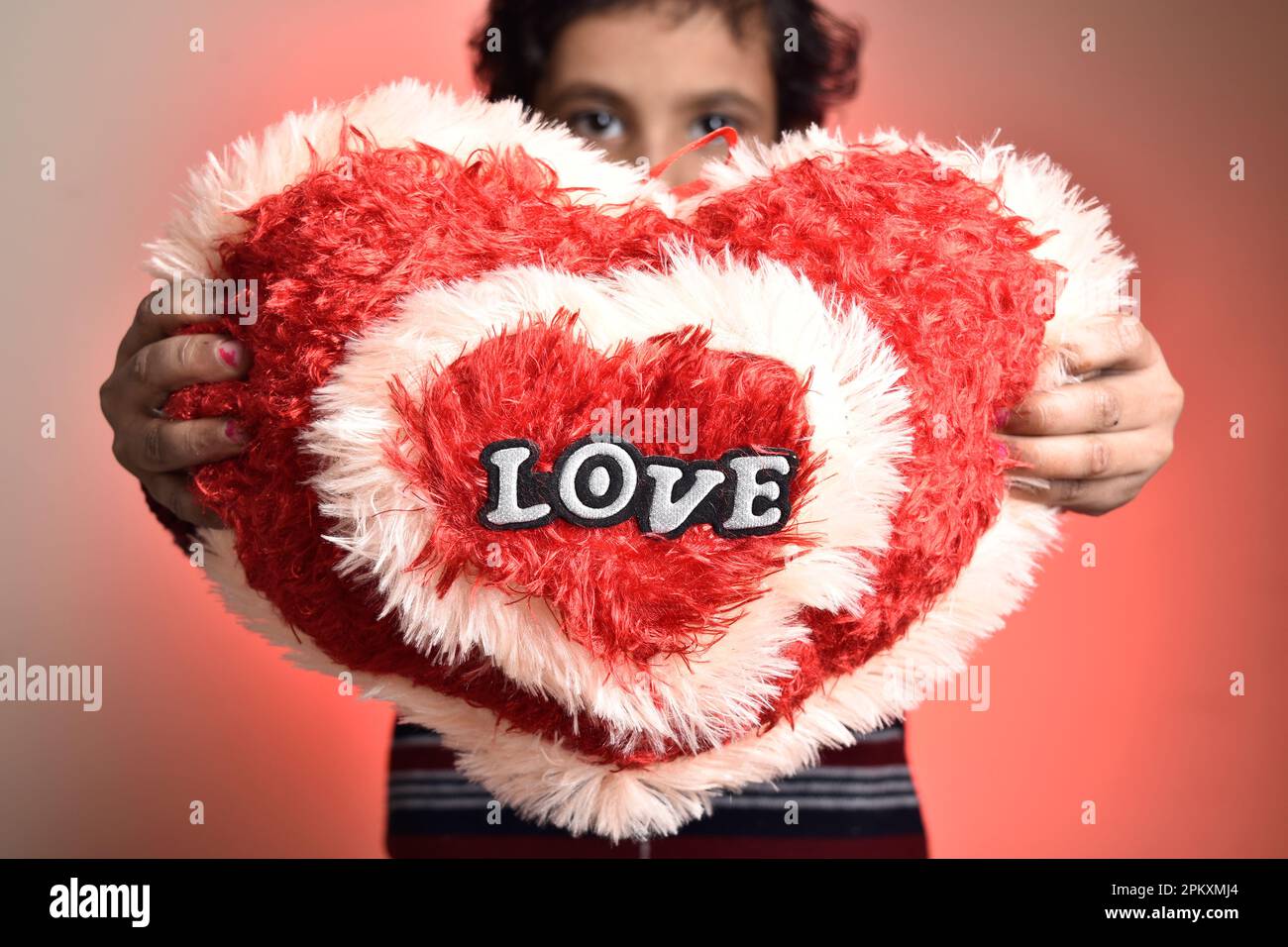 Heart shaped love soft toy in kid hand Stock Photo Alamy