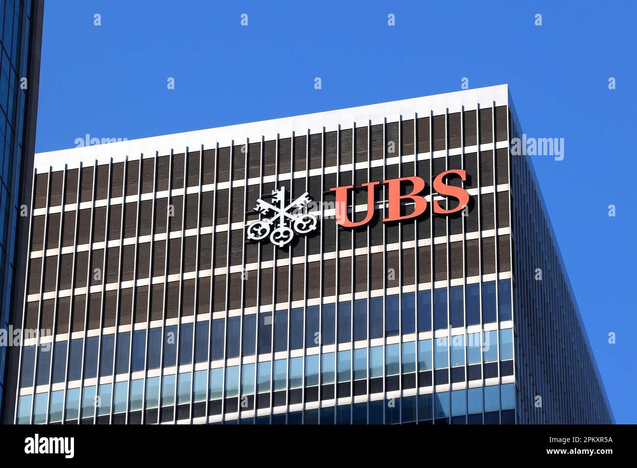 The logo of UBS AG can be seen from the street near their 1285 6th Ave headquarters building in New York City. Stock Photo
