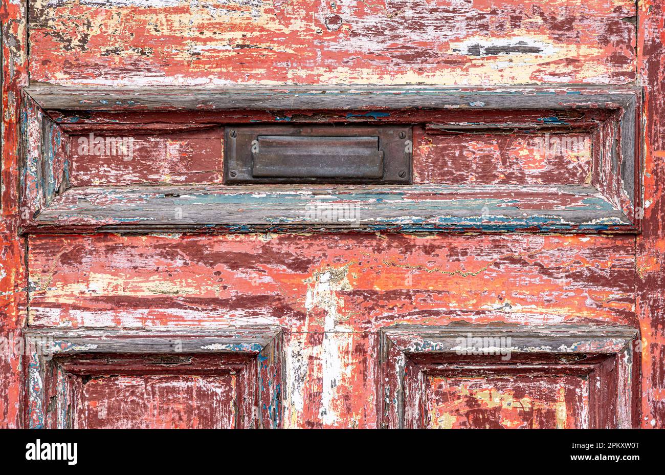 Detail of an old wooden door with layers of paint in Portsmouth, NH