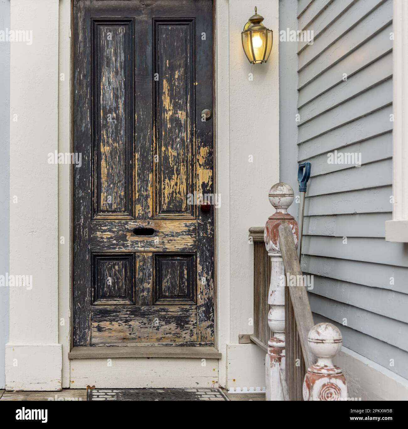 a well worn black external panel door in Portsmouth Stock Photo
