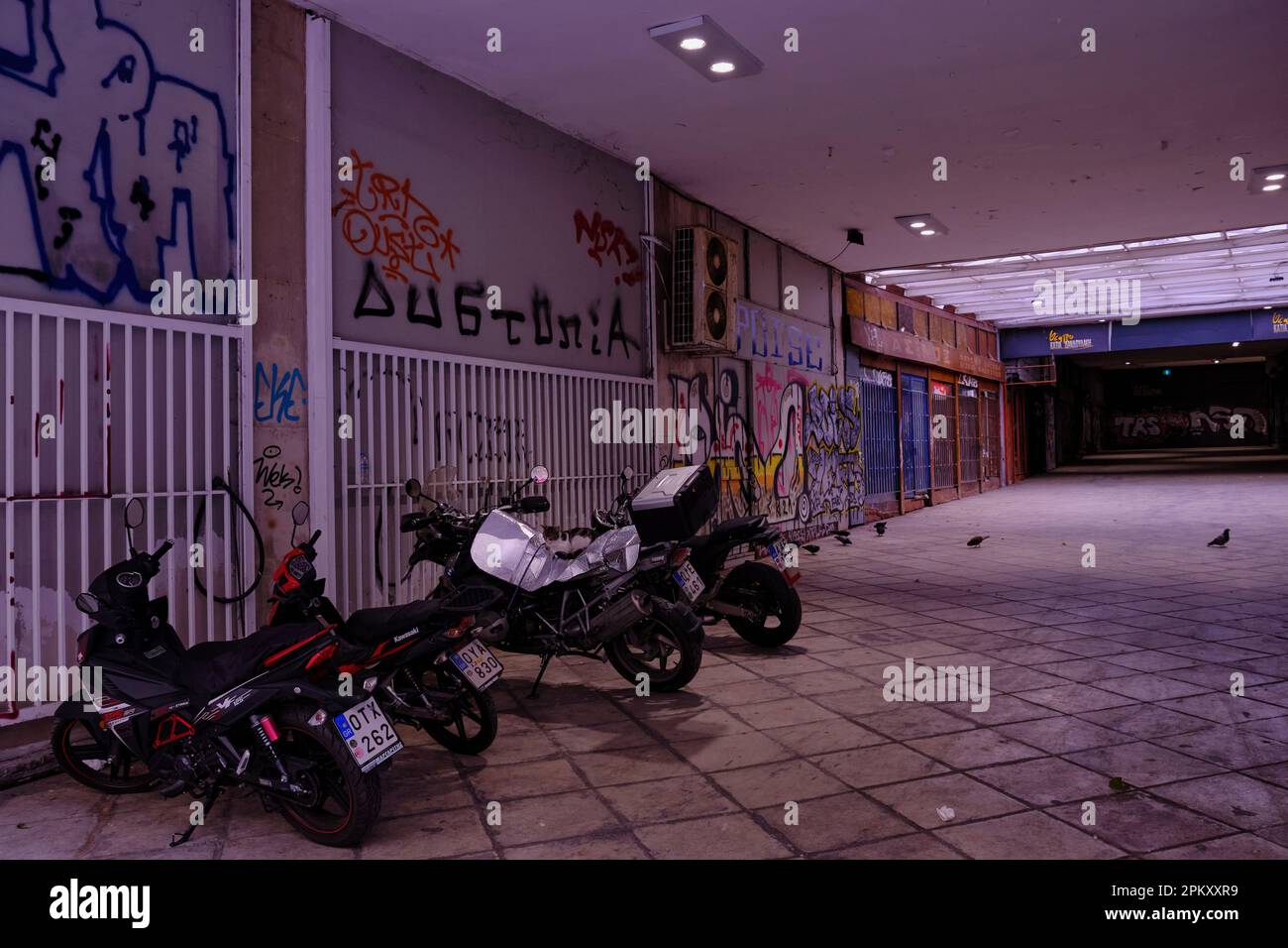 Motorcycles park in an Abandoned Shopping mall in central Athens Stock