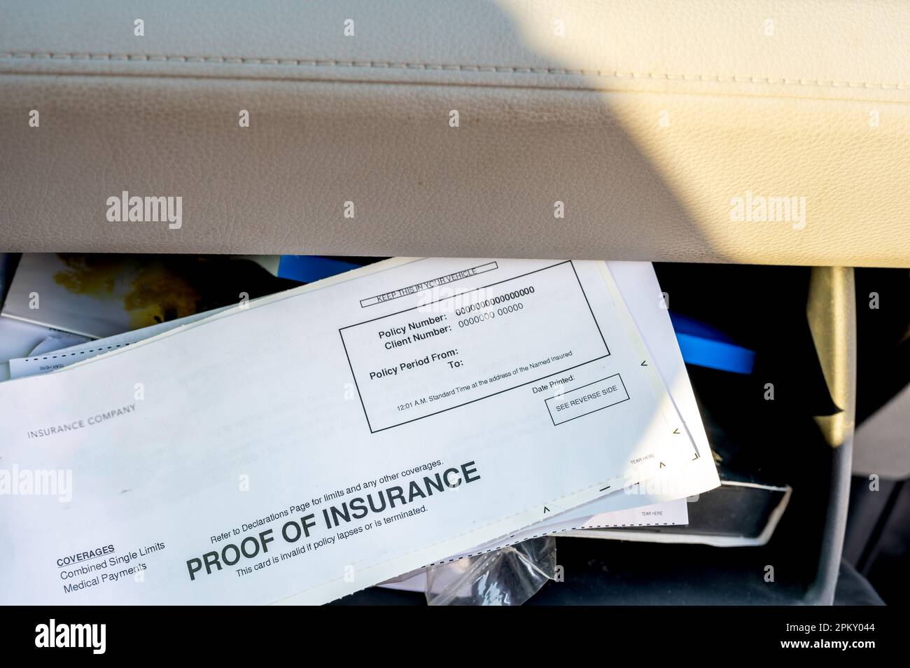 Proof of insurance and vehicle registration documents in the glove
