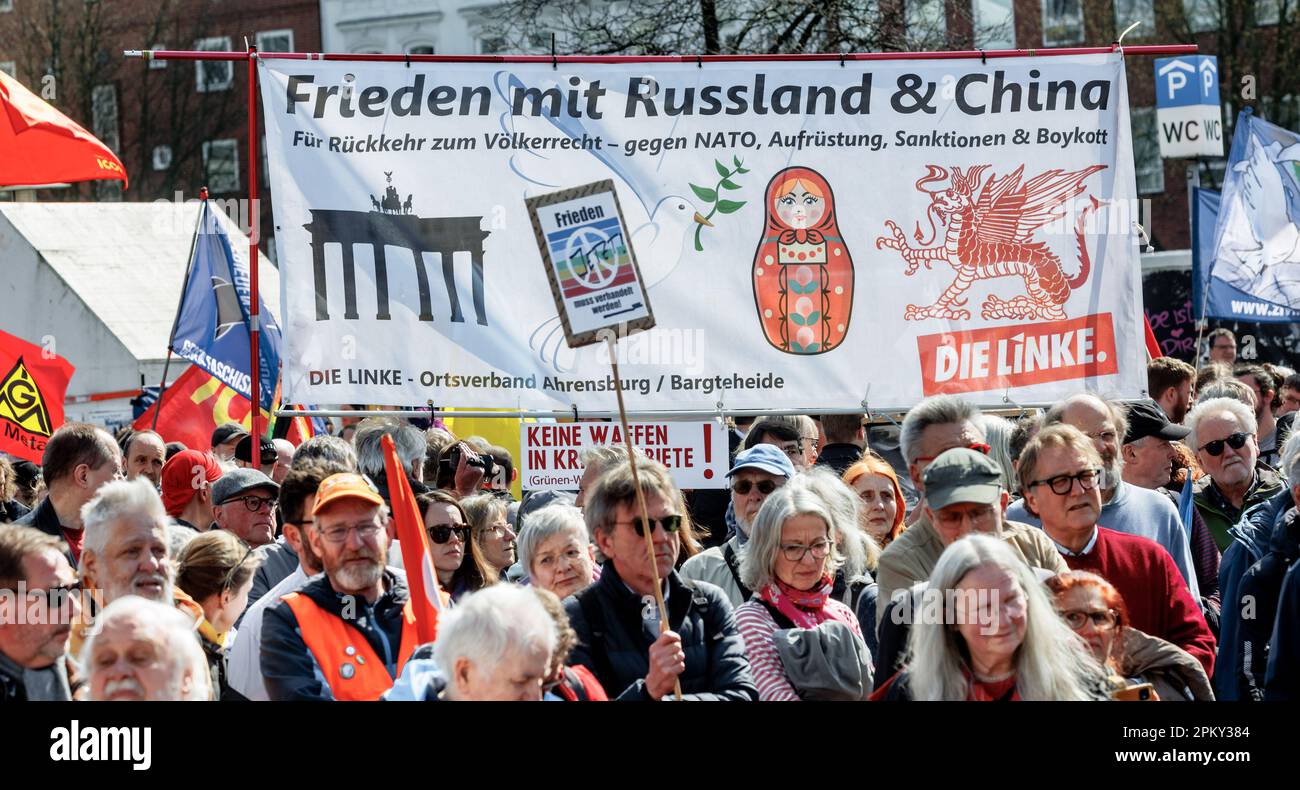 Hamburg, Germany. 10th Apr, 2023. Participants of the Hamburg Easter March hold a banner reading 'Peace with Russia and China. For a return to international law, against NATO, rearmament, sanctions and boycott'. Also in 2023, under the impression of Russia's war against Ukraine, numerous Easter marches took place throughout Germany. Credit: Markus Scholz/dpa/Alamy Live News Stock Photo