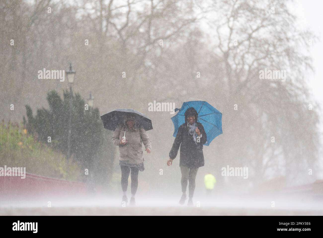 People brave the rainy conditions in Battersea Park, London, on Easter Monday, after a warm