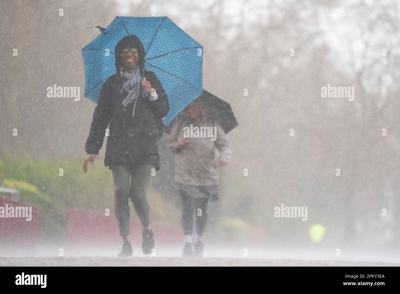 People brave the rainy conditions in Battersea Park, London, on Easter Monday, after a warm