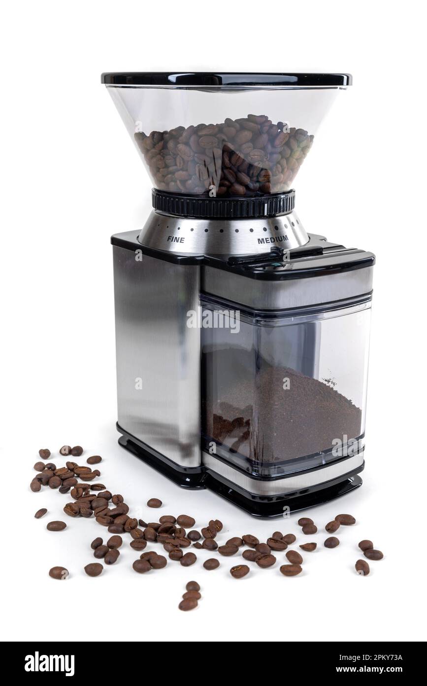 Coffee grinder with espresso roast beans over a white background Stock