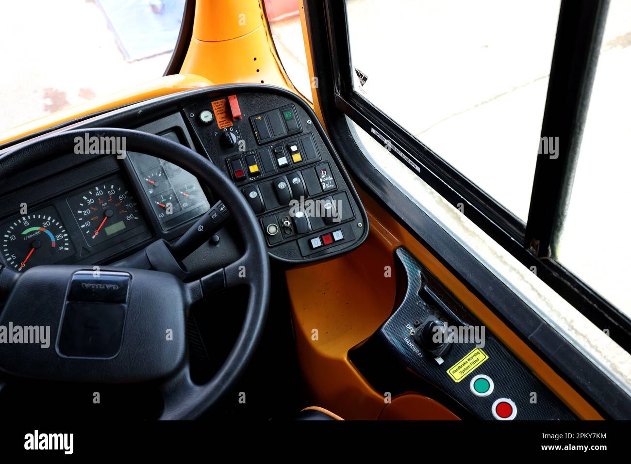 Bus drivers seat showing the drivers wheel and controls, Bradford, UK
