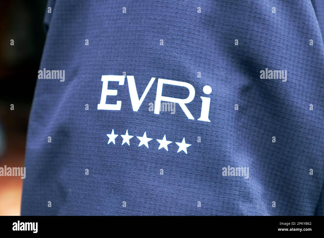 EVRI service provider logo sign letters on an Evri 5 star employee delivery van driver worker uniform jacket Wales UK 2023  KATHY DEWITT Stock Photo