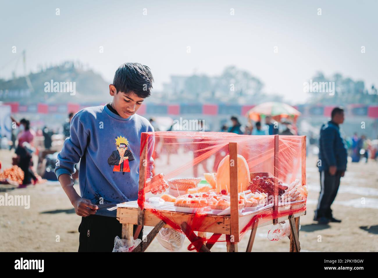 Kathmandu - Jan 22. 2023 : A Young Nepali Fruit seller looking for