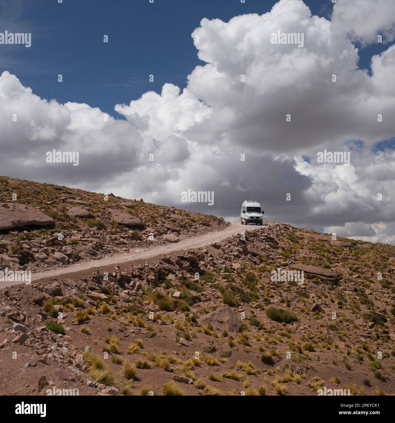Tourist mini bus driving on a desert track close to Laguna Miscanti, High Altiplano, Chile. Stock Photo
