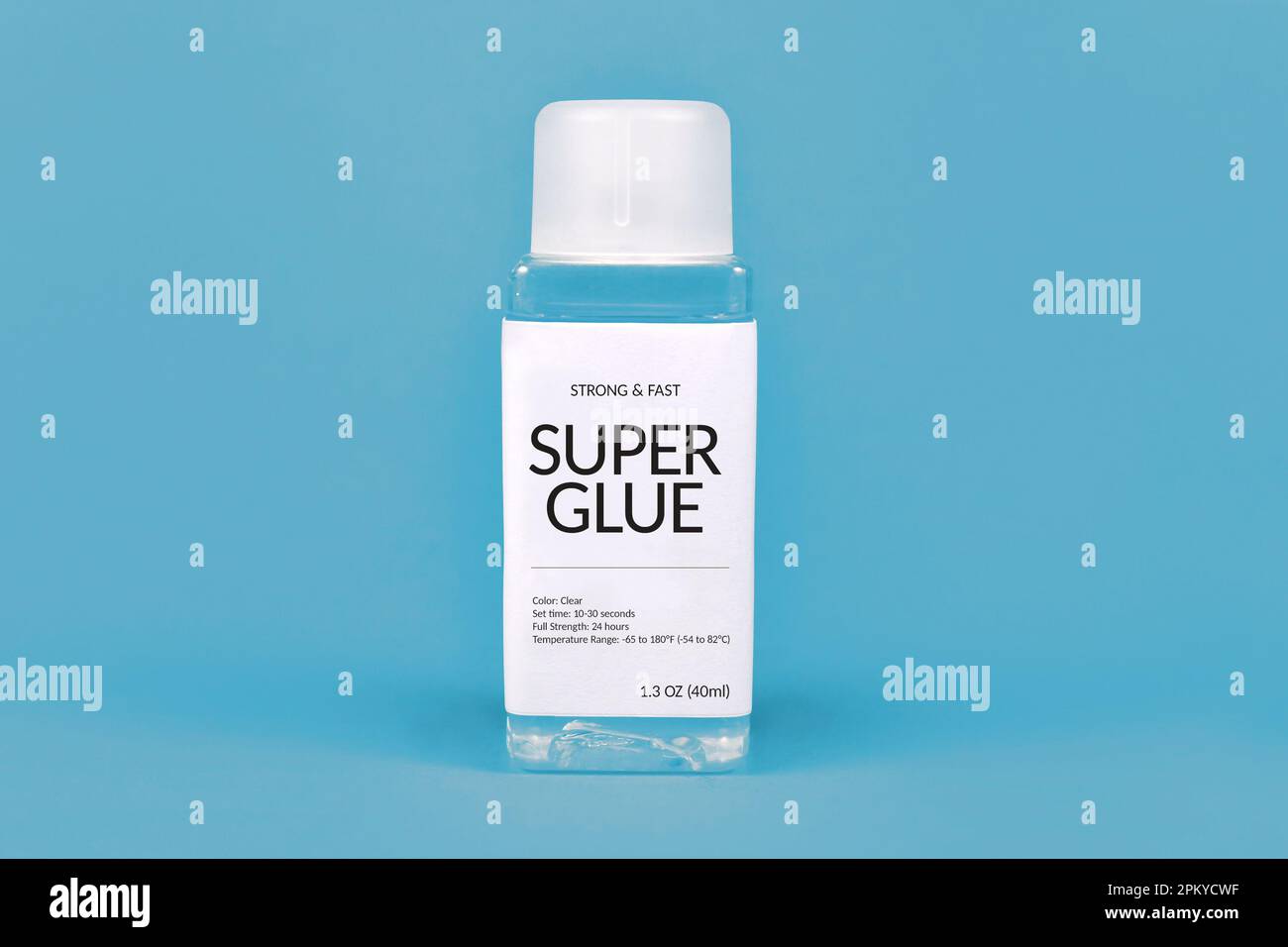 Super glue bottle on blue background Stock Photo