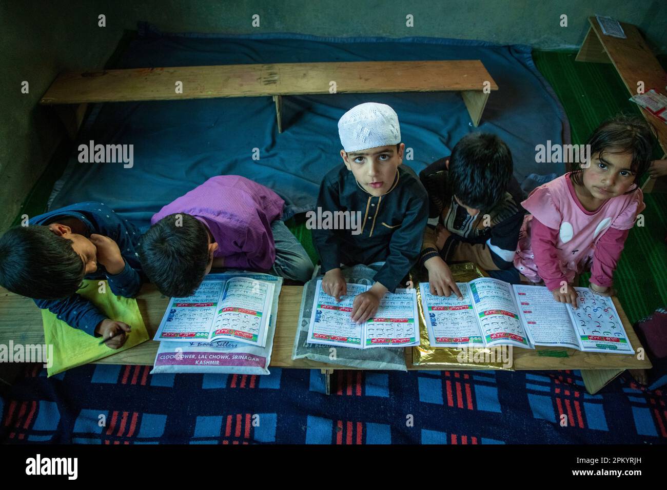 Srinagar, India. 09th Apr, 2023. Kashmiri Muslim children read the holy Quran at a local madrasa