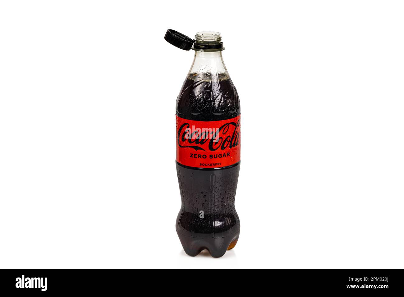 Close up view of plastic bottle of Sugar Free Coca Cola with open cap holding onto neck of bottle. Sweden. Stock Photo