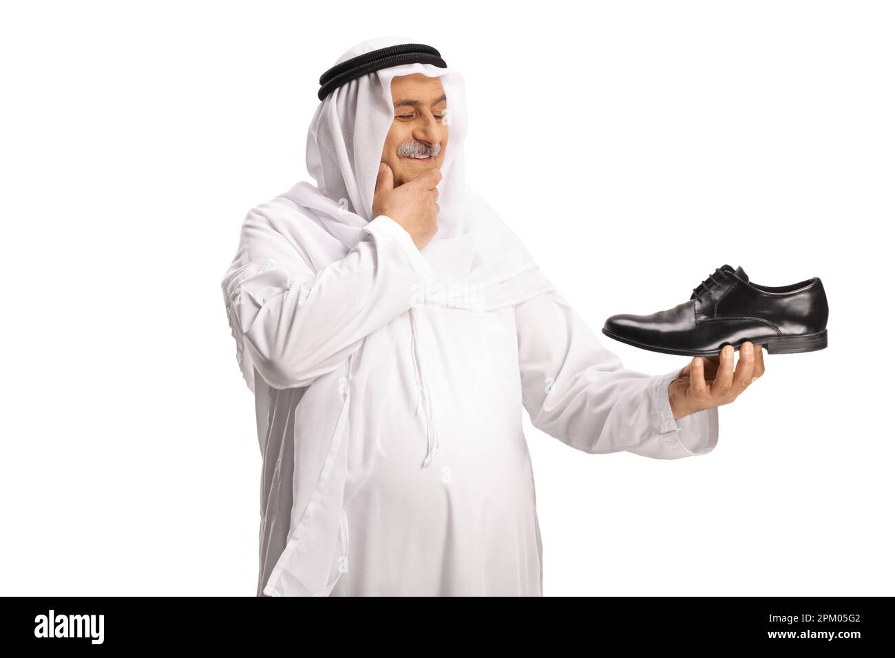 Arab man holding a black leather shoe and thinking isolated on white background Stock Photo