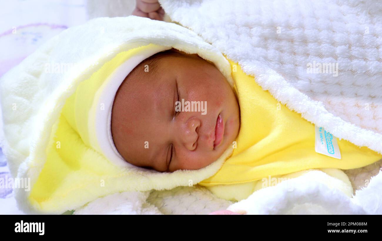 Newborn baby in deep sleep covered in blankets Stock Photo - Alamy