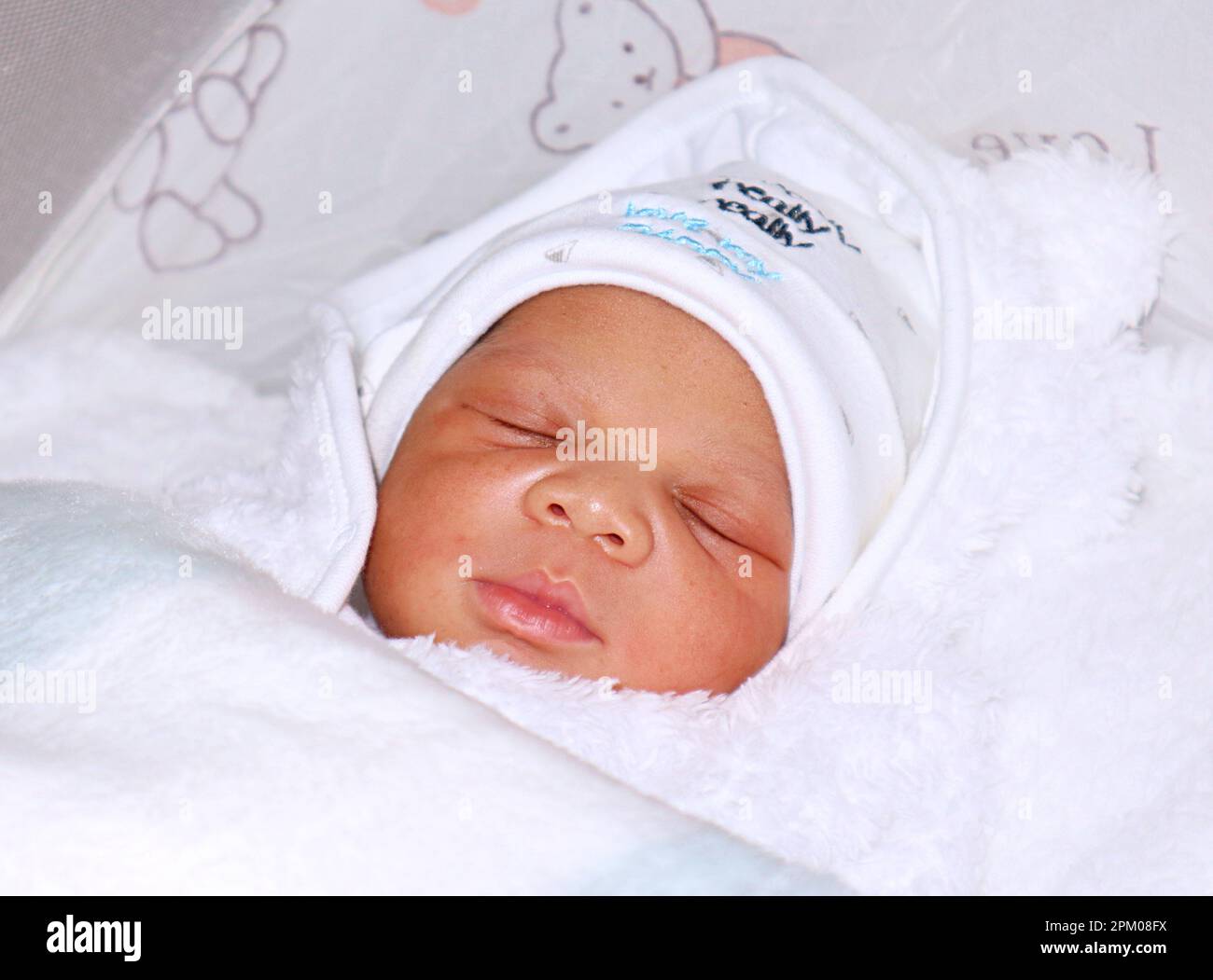 Newborn baby in deep sleep covered in blankets Stock Photo Alamy