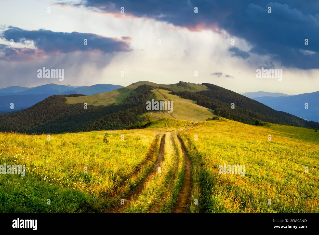 Rural road and beautyful raining dramatic sky. Amazing scene in summer ...