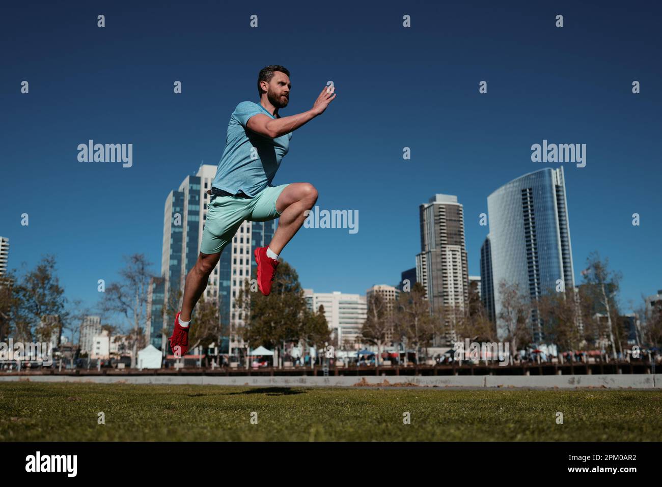 Athletic young man running in the nature. Dynamic movement Stock Photo ...
