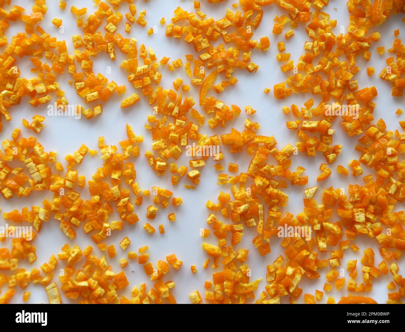 finely chopped orange peels on white table for food background Stock ...