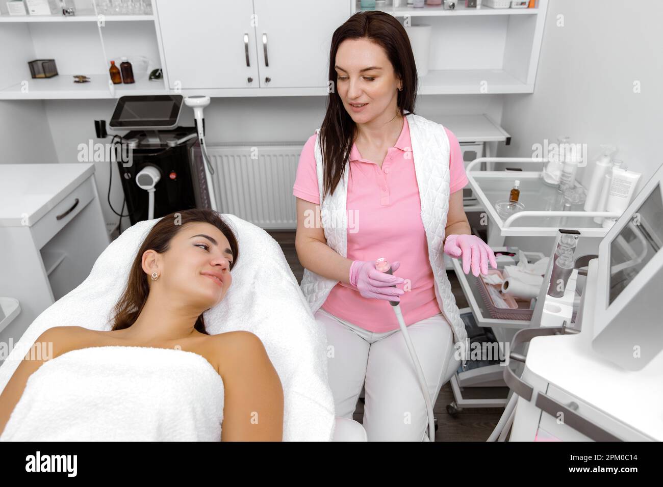 Rejuvenation treatment,Cosmetology service,Blackhead removal,Cosmetologist consults with the client during the procedure Stock Photo