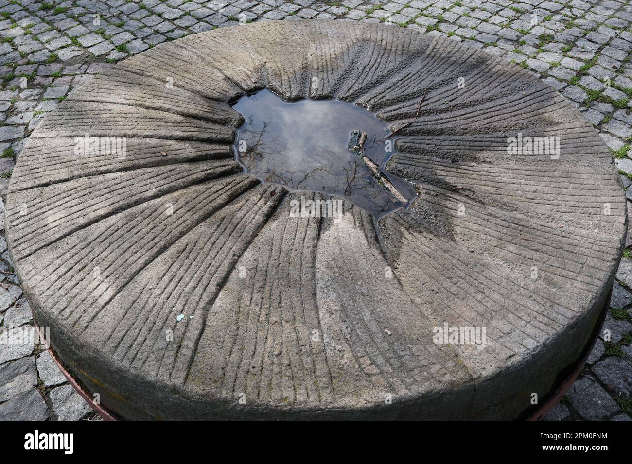 A part of the old ukrainian millstone is seen on the territory of the