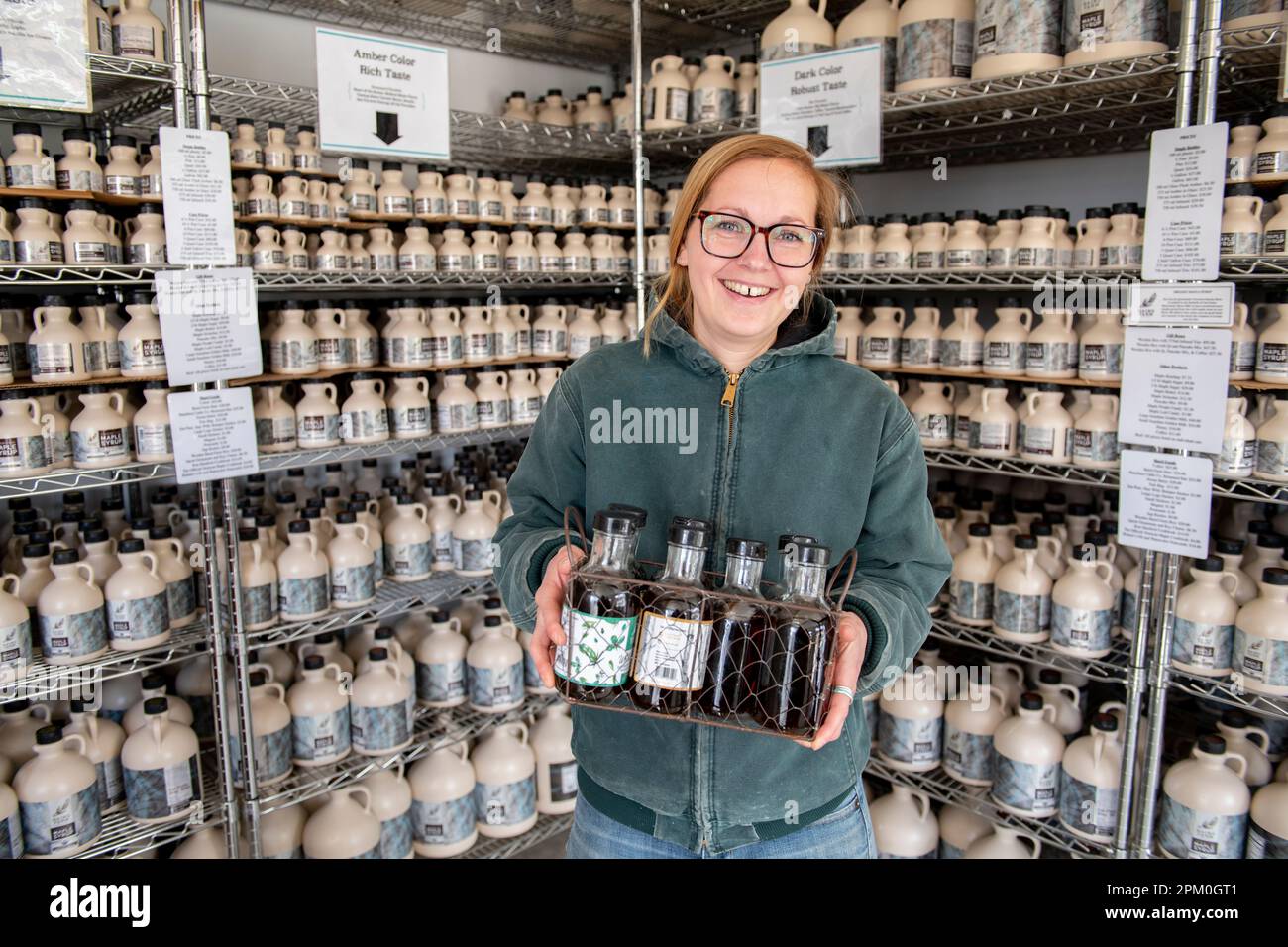 USA VT Vermont North Chittenden Baird Farm maple syrup makers small business - fourth generation Jenna Baird holding samples Stock Photo