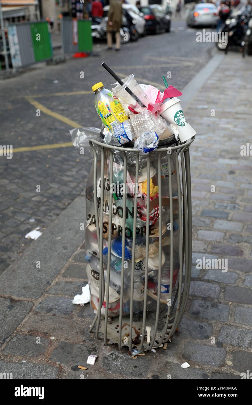 Paris, France, October 29, 2022 Parisian trash bin, overflowing with