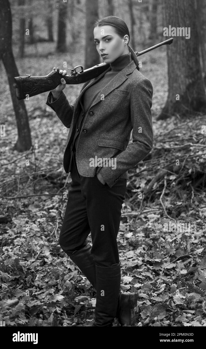 successful hunt. hunting sport. girl hunter in forest. girl with rifle