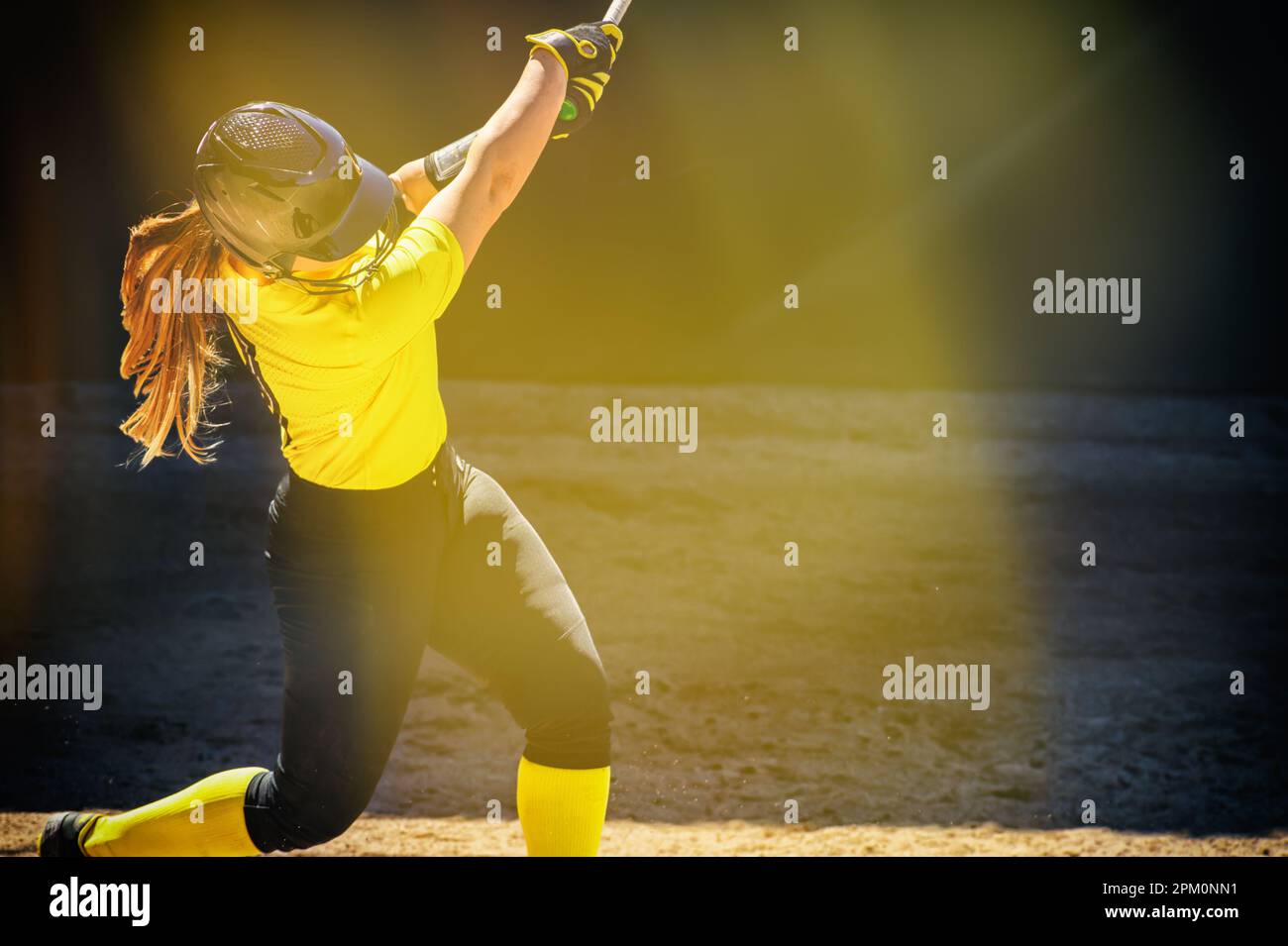 A Baseball Softball Player Is Swinging The Bat With A Soft Light Glare