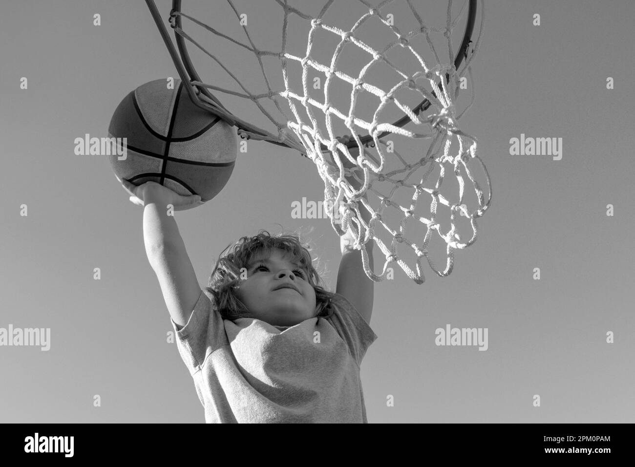 Basketball Slam Dunks of sporty kids basketball player. Close up image