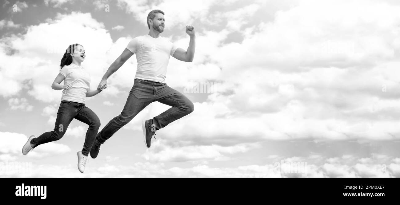 Father and daughter jump on sky, banner with copy space. energetic ...