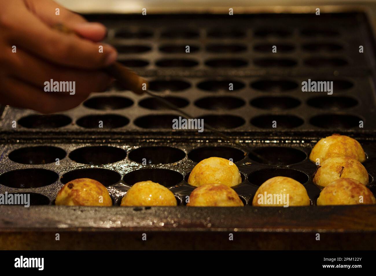 The cooking of Takoyaki. The popular Japanese street food Stock Photo