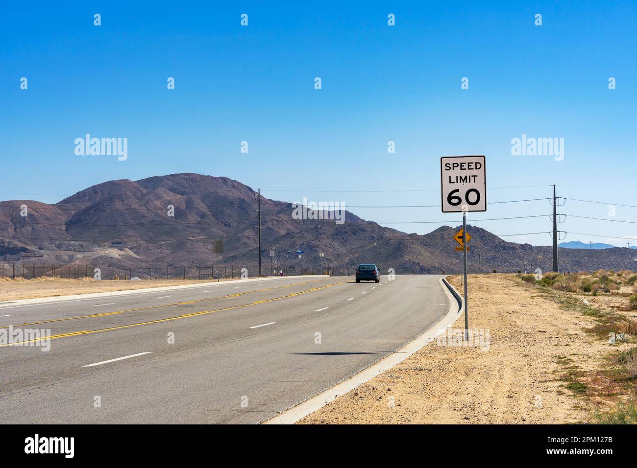A 60 Speed Limit street sign on a on rural road in the Mojave Desert in California Stock Photo