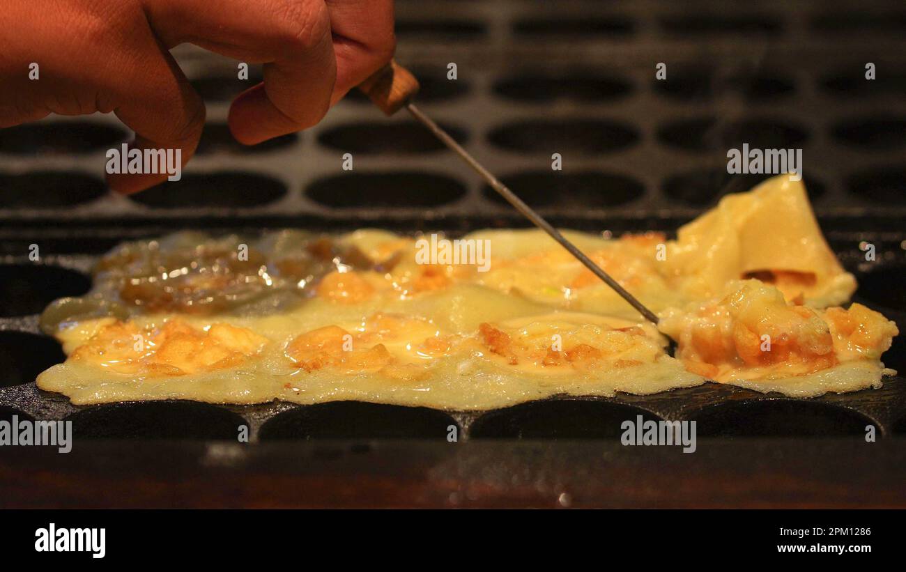 The cooking of Takoyaki. The popular Japanese street food Stock Photo