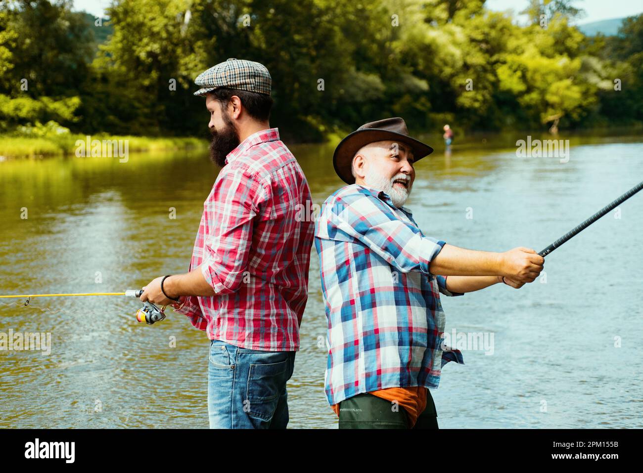Father and adult son fishing in lake. Family time. Man bearded fisher.  Fishing team. Big game fishing. Retired bearded fisher. Keep calm and fish  on Stock Photo - Alamy