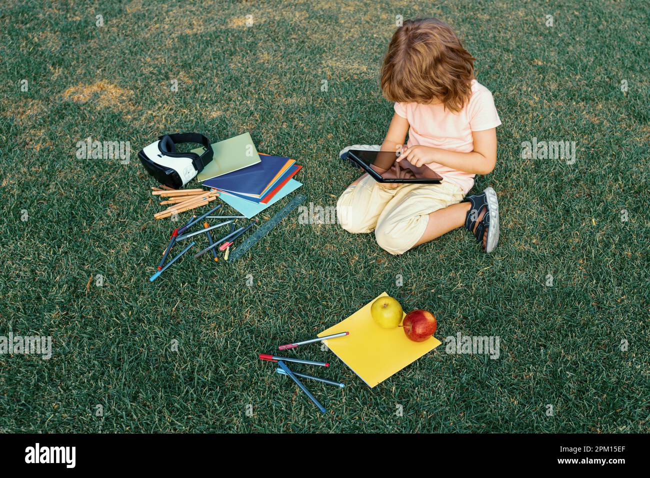 Child study exam outside. Funny kid little student boy with tablet ...