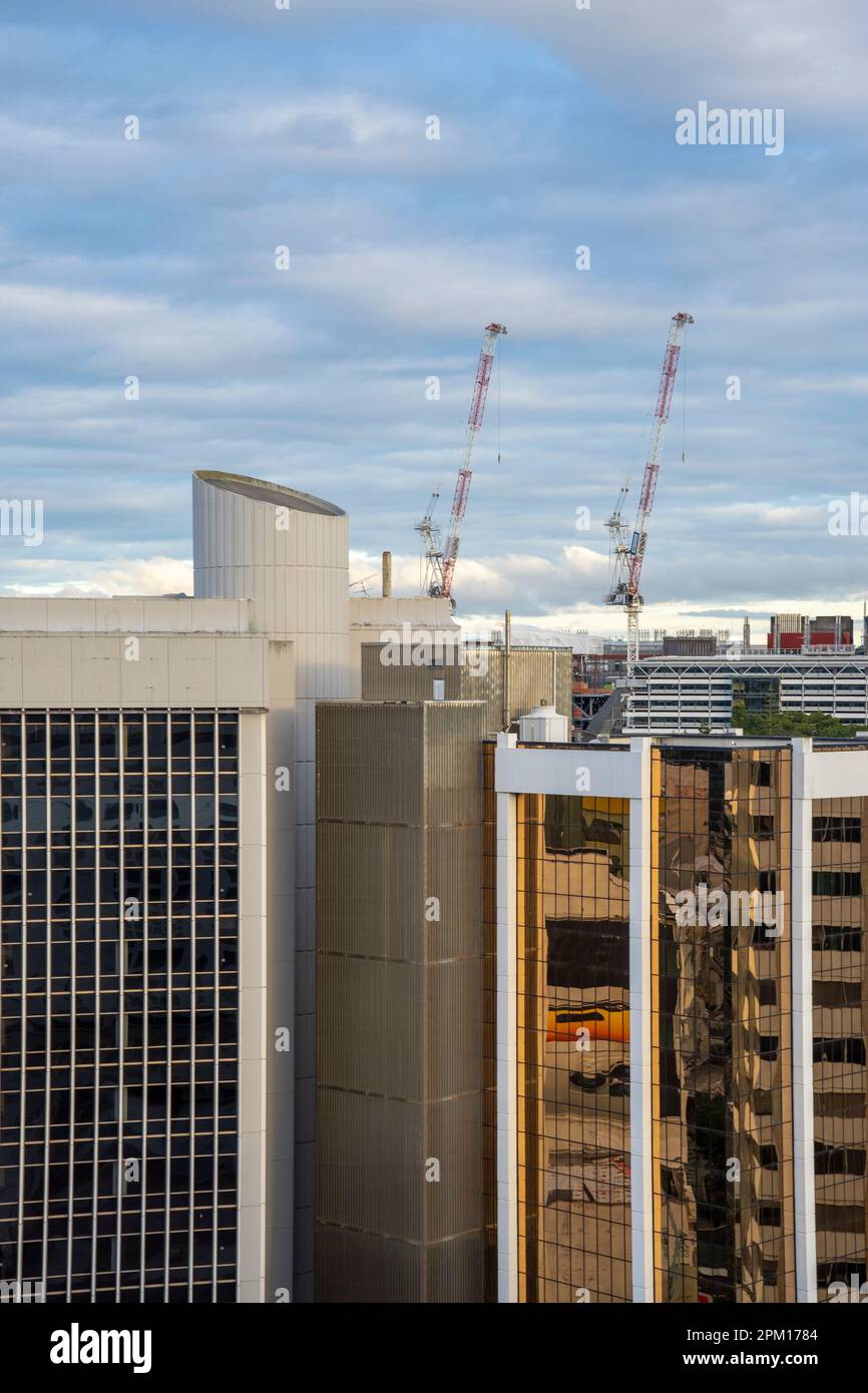 Bird's-eye view of construction cranes against a blue cloudy sky in the ...