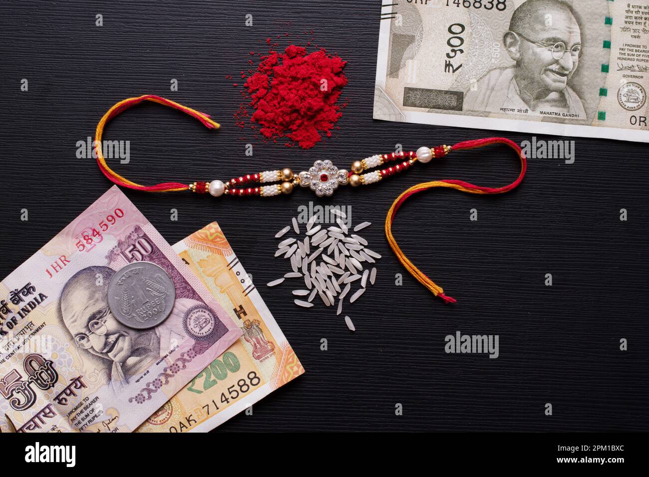 Top view of rakhi with indian money and roli chawal Stock Photo - Alamy