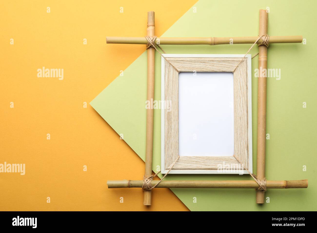 Empty bamboo frame on color background, top view. Space for text Stock ...