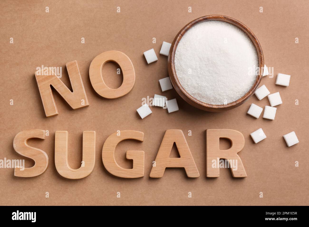 Flat lay composition with phrase No Sugar on brown background Stock Photo