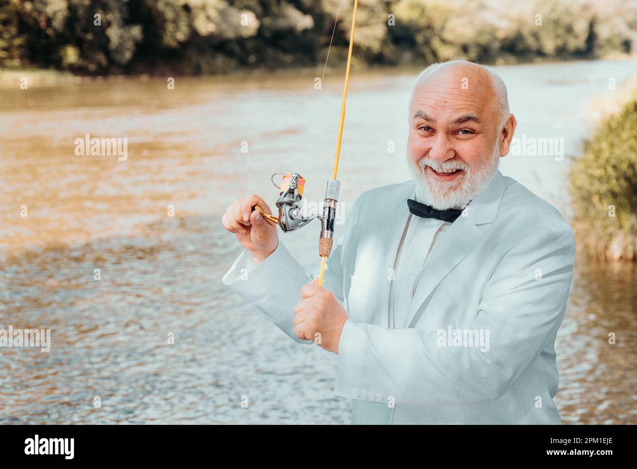 Fisherman in formal suit. Man fishing on river. Catch me if you can. Man  relaxing and fishing by lakeside. Man at riverside enjoy peaceful idyllic  Stock Photo - Alamy