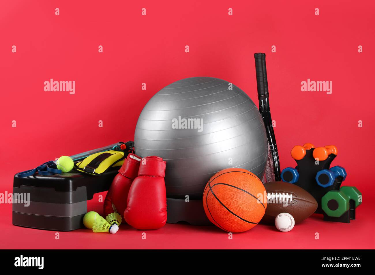 Set of different sports equipment on red background Stock Photo Alamy