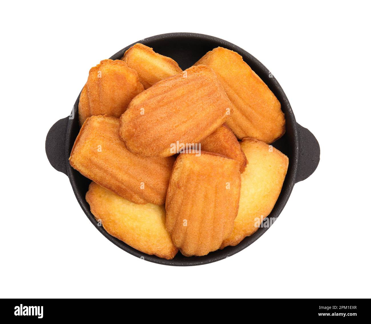 Frying pan with delicious madeleine cakes on white background, top view