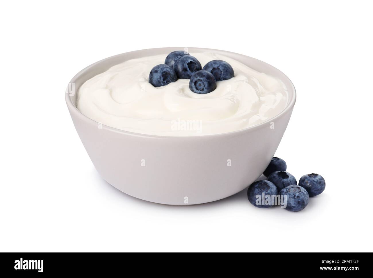Bowl of delicious yogurt with blueberries on white background Stock Photo