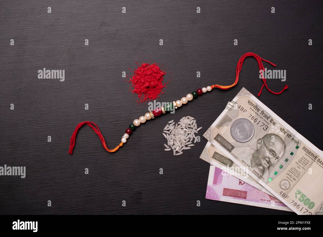 Top view of beads rakhi with roli and indian currency Stock Photo