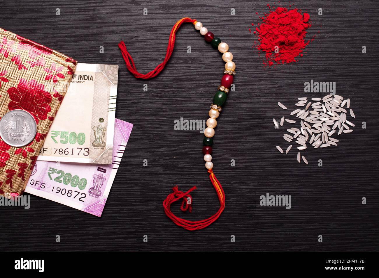 Top view of rakhi with roli chawal and indian currency, raksha bandhan ...