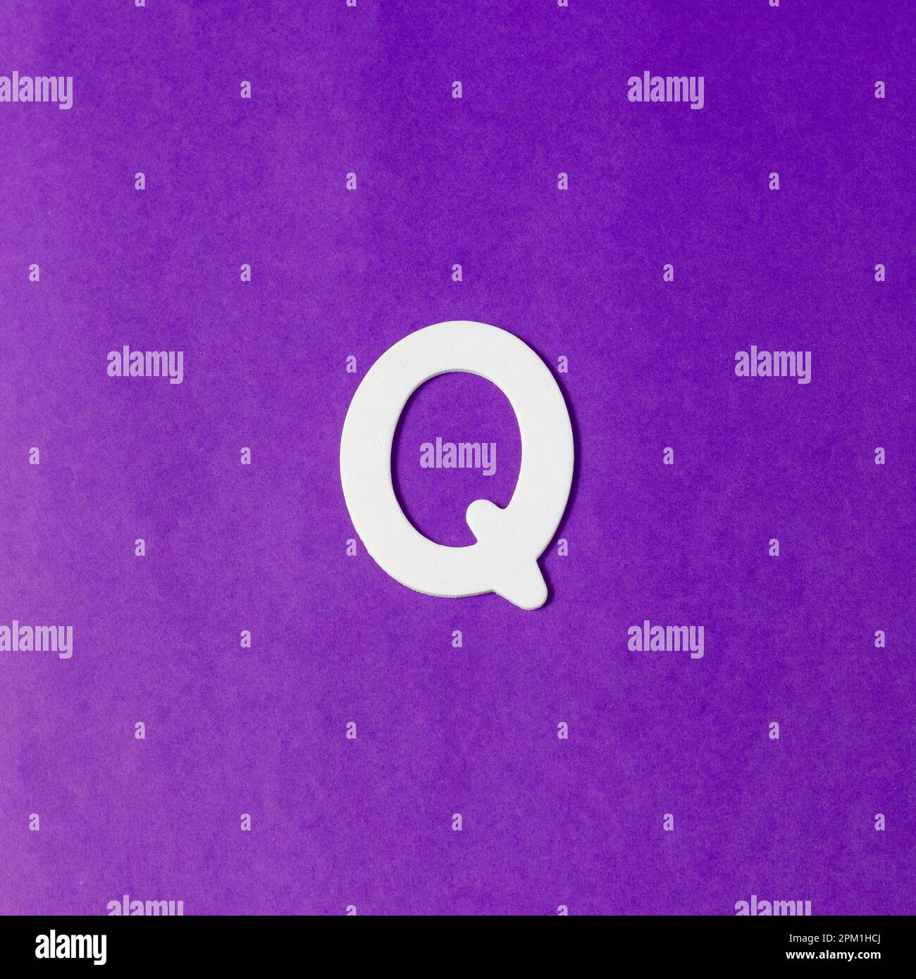 Letter Q in wood texture - Purple background Stock Photo