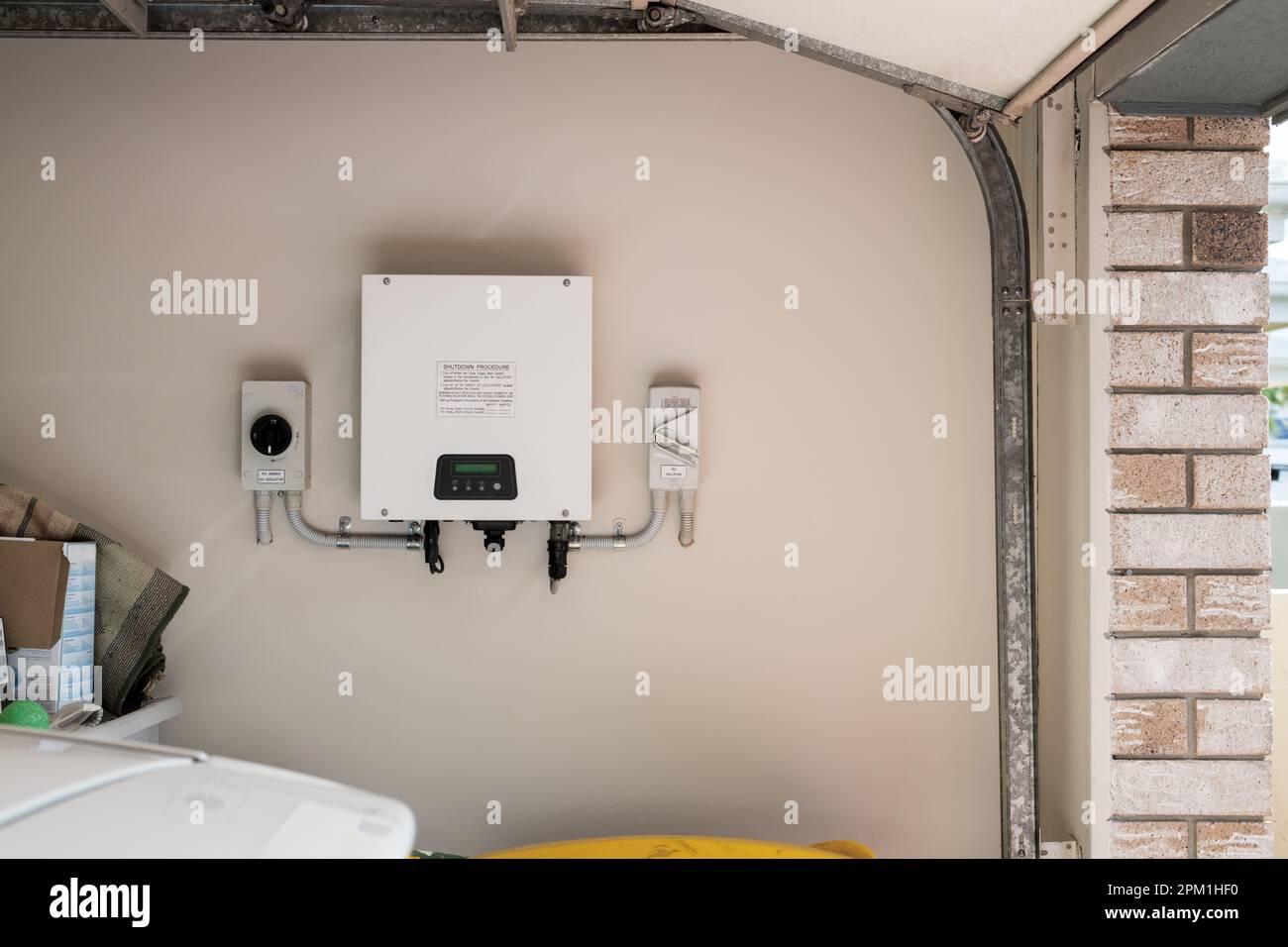 Solar power inverter mounted inside garage of a house, domestic system Stock Photo