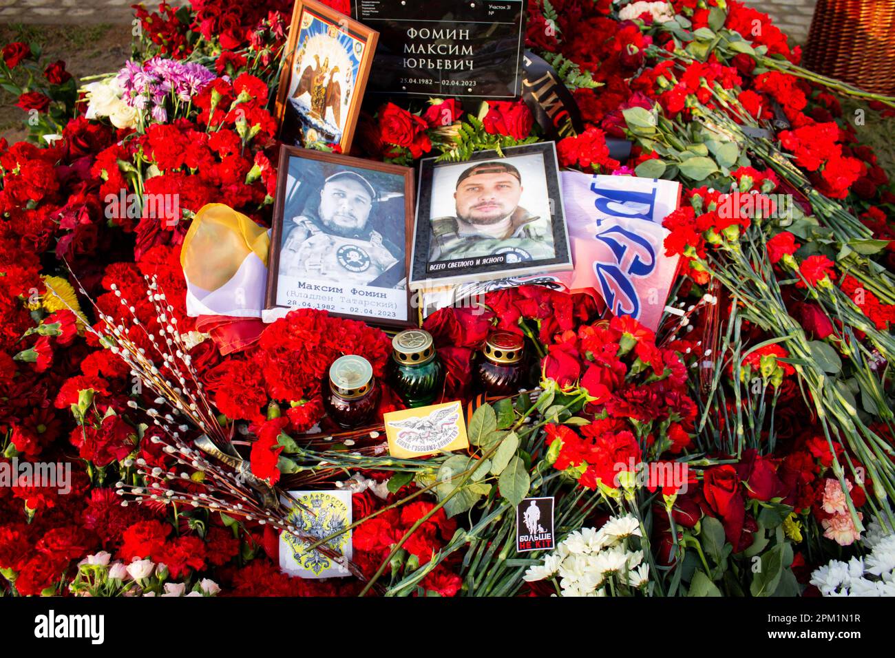Pictures of Vladlen Tatarsky and flowers seen at his grave at Troyekurovskoye cemetery in Moscow. Maxim Fomin better known by his pen-name Vladlen Tatarsky was a convicted criminal who escaped from prison and made a name for himself as a Ukrainian-born Russian military blogger and a participant in the war between Russian and Ukraine. He was active as a propagandist for the Russian side in the war until he was murdered in a terrorist act in St. Petersburg on April 2, 2023. 26-year-old woman named Darya Trepova was arrested for the bombing that had killed Tatarsky and injured dozens of others. Stock Photo